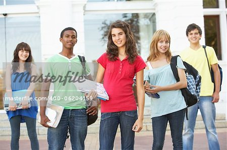 Group Of Teenage Students Standing Outside College Building