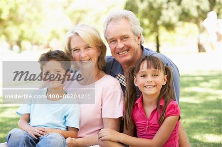 Grandparents And Grandchildren Enjoying Day In Park