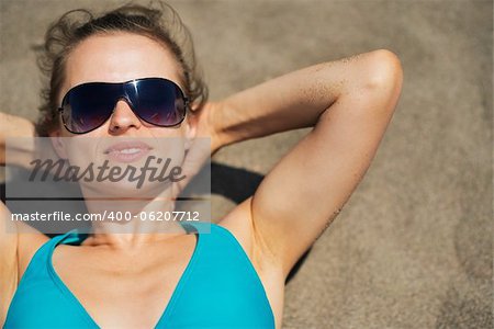 Woman laying on beach sand