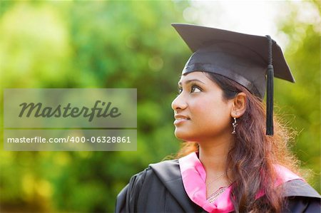 Smiling Young Asian Indian female student looking away with copy space