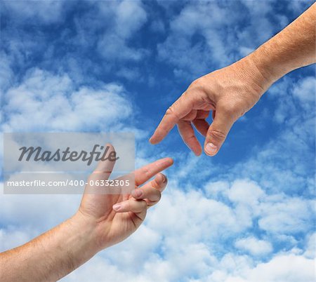 Two hands reaching towards each other blue sky background