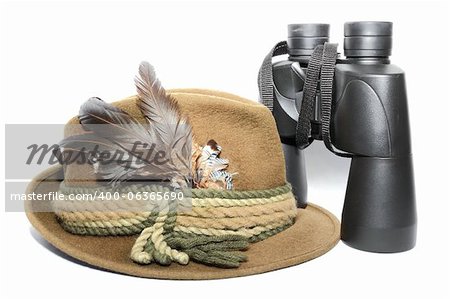 display of a hunting hat and binoculars over white