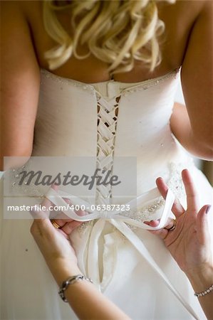 tying a bow in a wedding dress