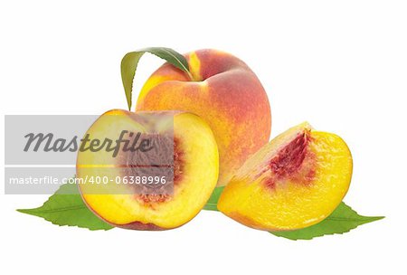 Fresh juicy peaches over green leaves isolated on white background