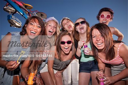 Group of happy girls with bubbles at amusement park
