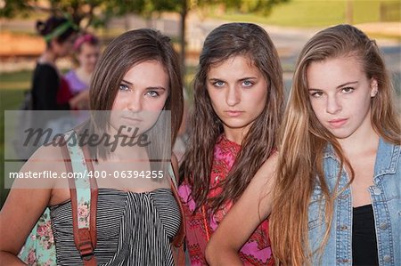 Trio of tough stylish teenage female students hanging out