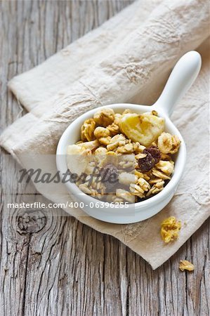 Healthy homemade granola cereal on an old wooden board.