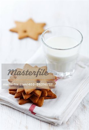 gingerbread stars and a glass of milk on a tea towel