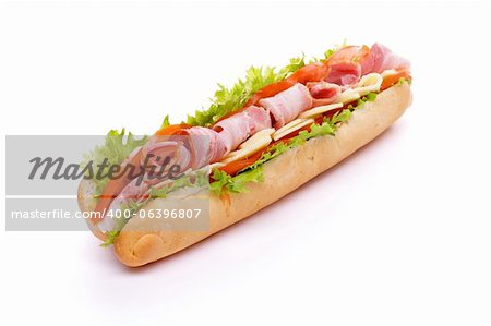 Big Sandwich on Long Baguette with Lettuce, Tomatoes, Cheese and Ham isolated on white background