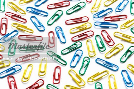 colorful paperclips on white background