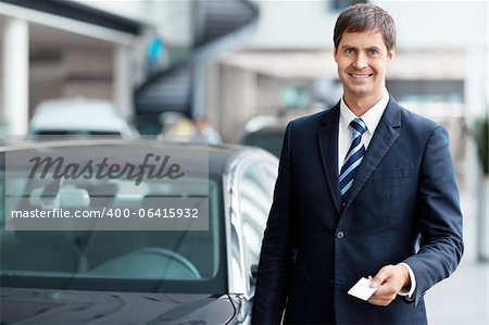 Seller with a business card in the showroom