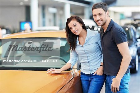 Attractive couple chooses a car