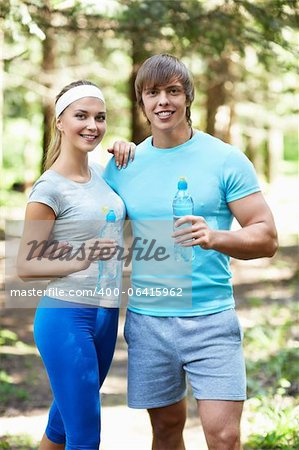 Smiling people with a bottle of water