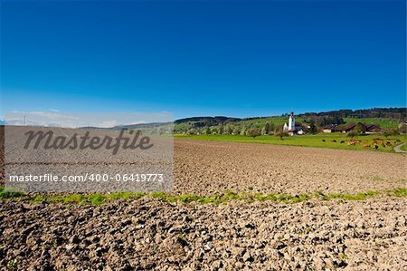 The Swiss Village Surrounded by Forests and Plowed Fields