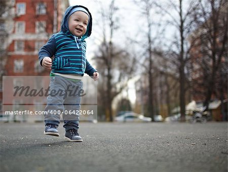 The first independent steps of the kid. Natural colors, shallow dof.