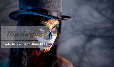 Sugar skull girl in tophat in the forest, Halloween theme