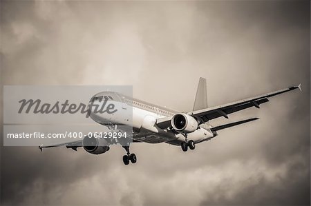 sepia toned passenger aircraft landing in turbulence