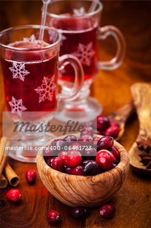 Cranberries in wooden bowl with hot mulled wine