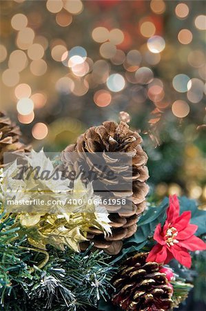 Christmas Decoration Garland with Poinsettia Pine Cones and Colorful Blurred Bokeh Lights Background