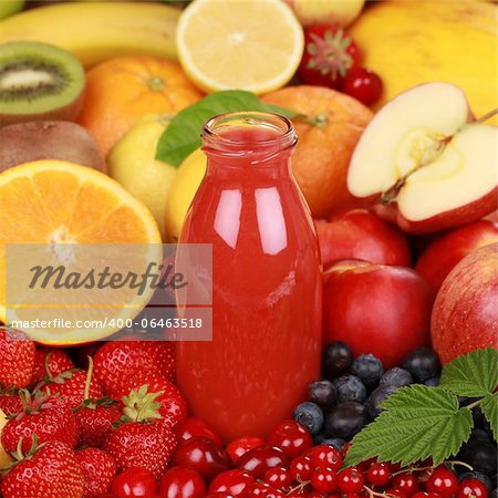 Freshly squeezed juice from red fruits such as apples, cherries and strawberries in a bottle