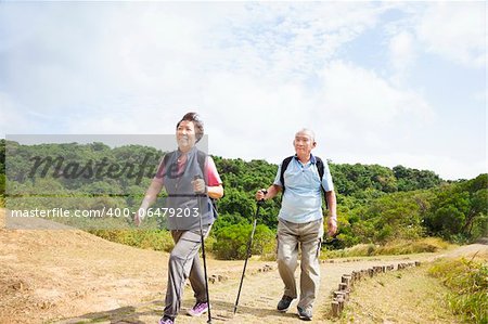 happy asian senior couple hiking