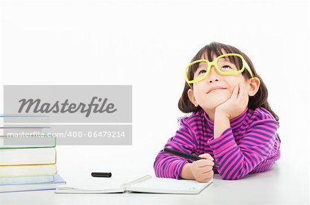 little girl  thinking or dreaming during preparing homework