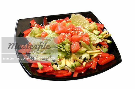 salad with a salmon, avocado, pepper and leaves of lettuce