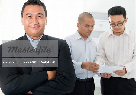 Southeast Asian business men in office