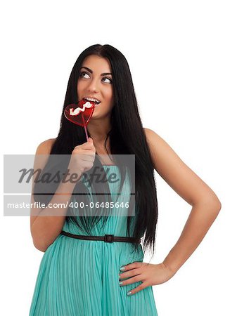 Girl holding heart candy. Studio shot over white background