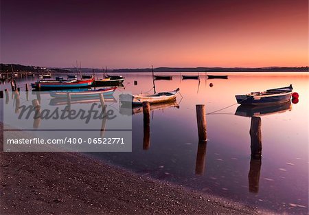 Beautiful landscape of a river and boats at sunset