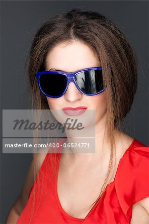 portrait of a beautiful woman in a red dress and glasses