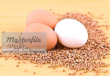 Three eggs and buckwheat on top of spaghetti