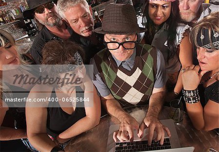 Mature nerd troubleshooting a computer with biker gang