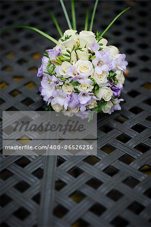 bridal bouquet of roses on a metal table