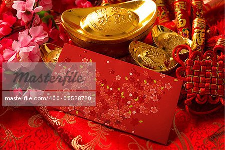 Chinese new year festival decorations, ang pow or red packet and gold ingots.