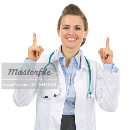 Smiling medical doctor woman pointing up