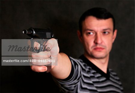 The man with a pistol on a background