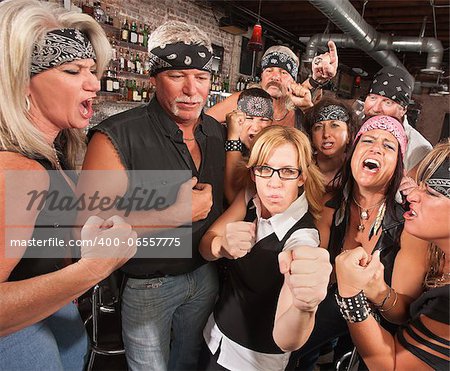 Motorcycle gang and female nerd holding up fists in bar