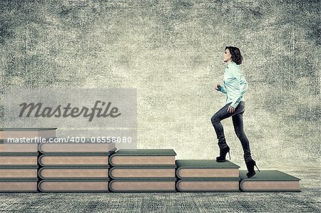 The girl rises upwards on a ladder from books