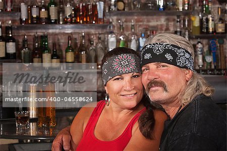 Cute motorcycle gang husband and wife together in bar