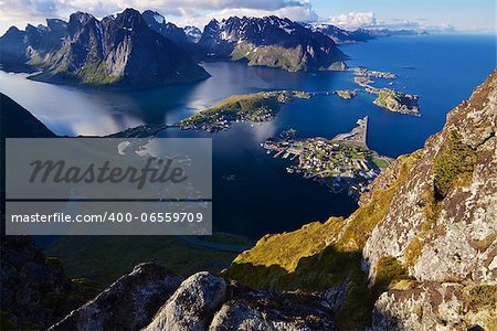 Scenic view of Lofoten islands from top of mountain Reinebringen with picturesque town of Reine and surrounding fjords