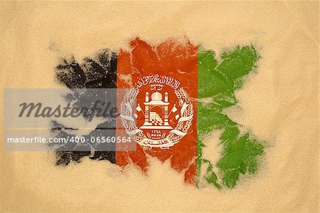 wrinkled Afghanistan flag buried in sand