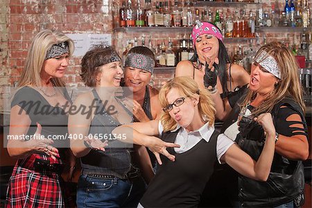 Nerd flexes muscles for tough female gang in bar