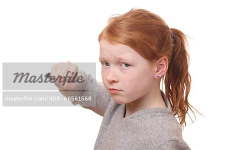 Portrait of an angry young girl on white background