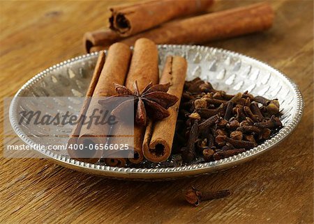 cinnamon, anise and clove on a silver plate