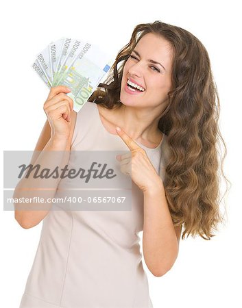 Smiling young woman pointing on euros