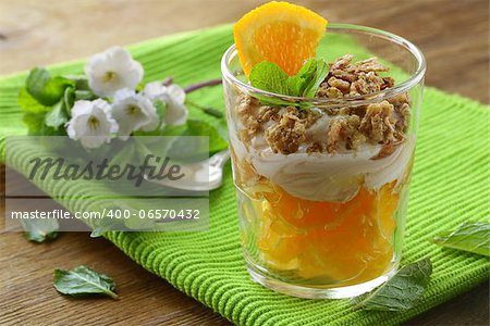 orange dessert with cream and biscuits in a glass
