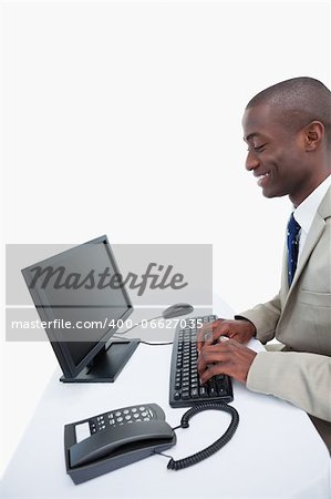 Side view of a businessman using a computer against a white background