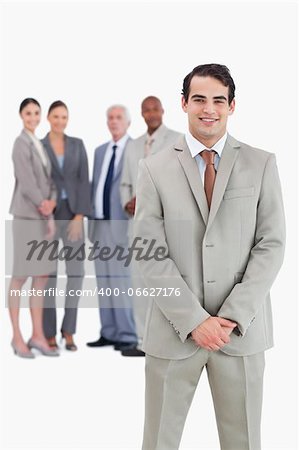 Businessman with team behind him against a white background