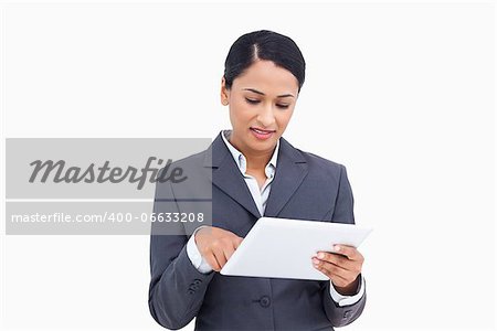 Close up of saleswoman with her touch screen computer against a white background